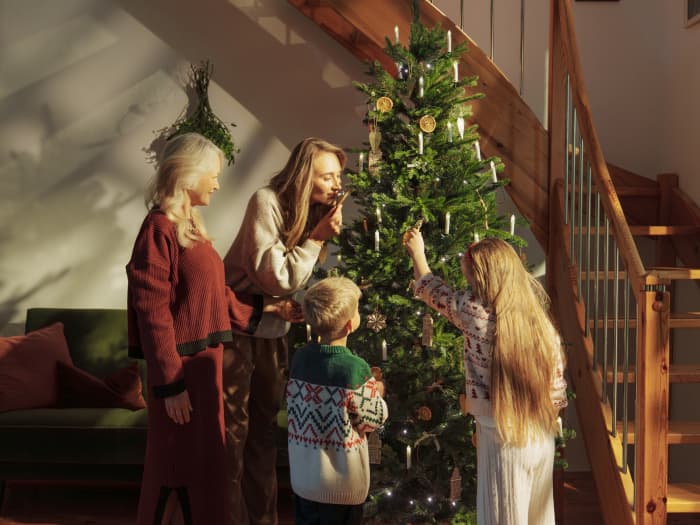 Family decorating a FairyTrees FT33 Christmas tree for Christmas