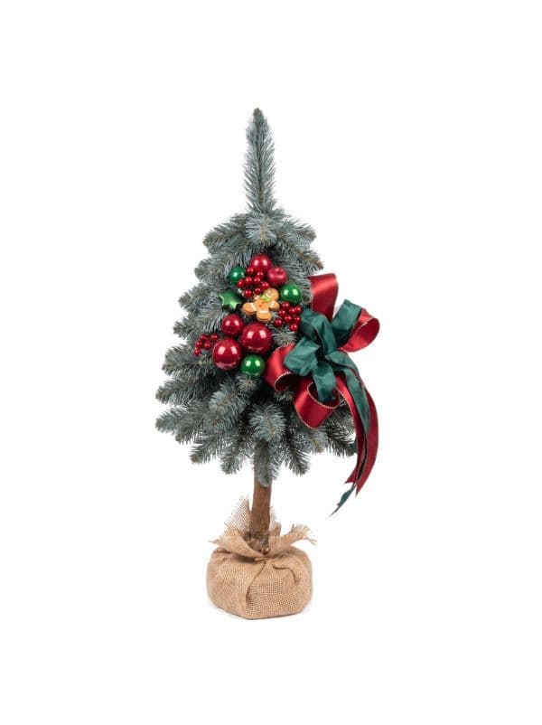 Small artificial Christmas tree on a trunk 65 cm on a white background, with silvery-green needles and festive ornaments. 