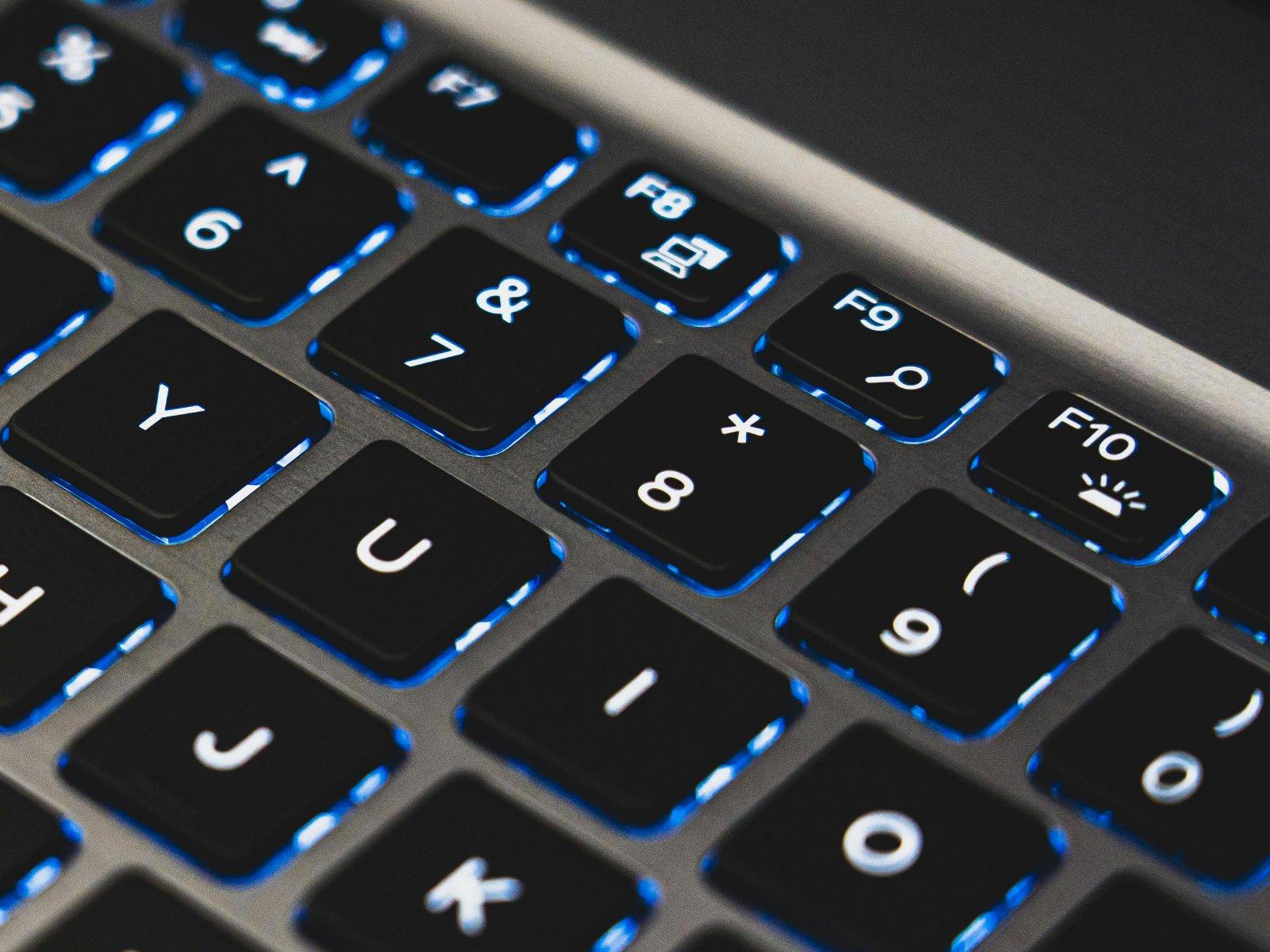 Close-up of a laptop keyboard with an asterisk hidden under the number 8.