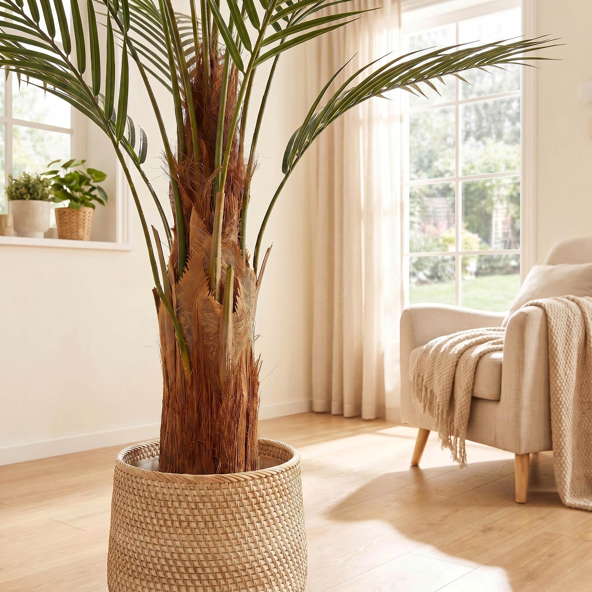 FairyTrees 160 cm artificial monstera on a stem placed in a cozy living room, as part of a natural interior design.