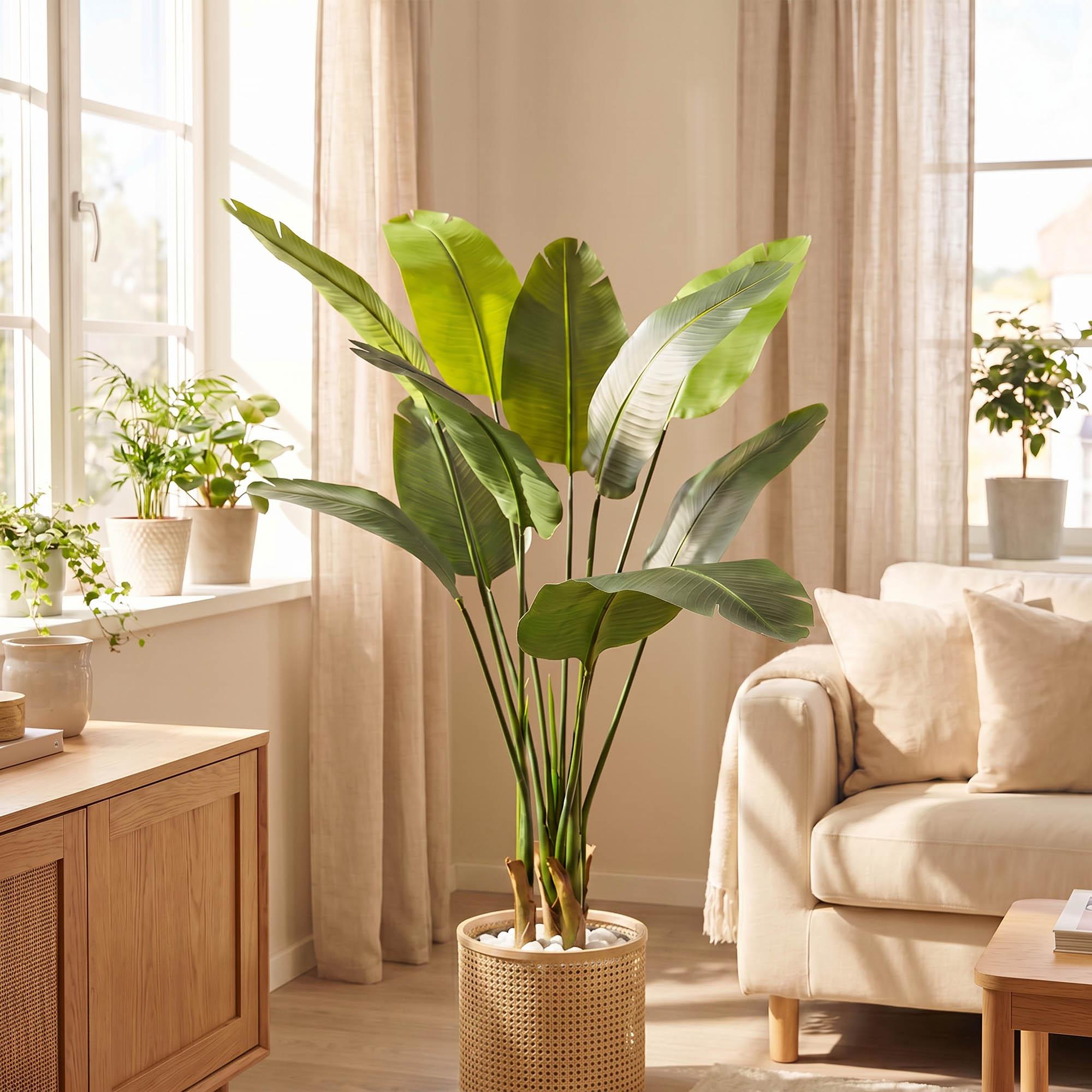 FairyTrees 160 cm artificial monstera on a stem placed in a cozy living room, as part of a natural interior design.