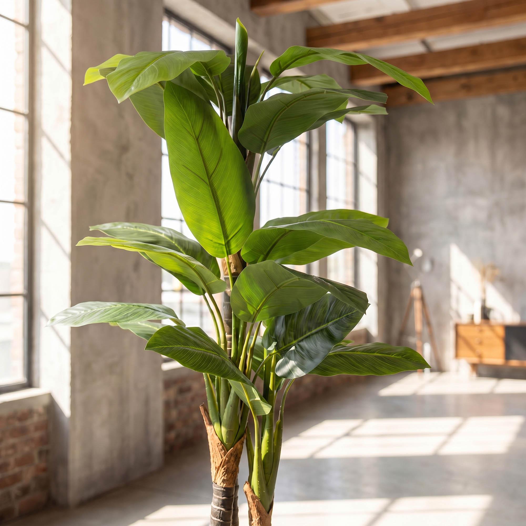 FairyTrees 160 cm artificial monstera on a stem placed in a cozy living room, as part of a natural interior design.
